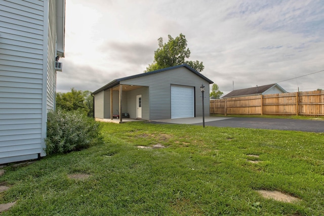 detached garage featuring fence