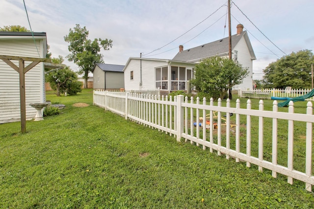 view of yard featuring fence private yard and a sunroom