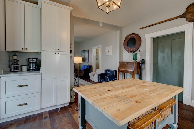 kitchen with dark wood-style floors and white cabinetry