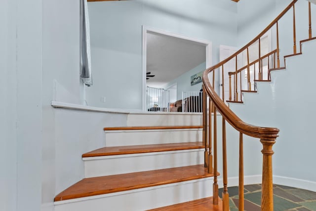 stairway featuring baseboards