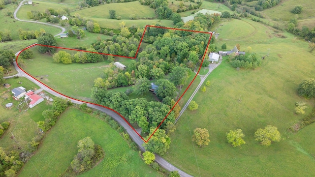 birds eye view of property with a rural view