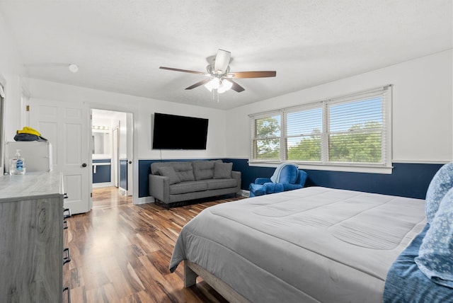 bedroom with a textured ceiling, ceiling fan, wood finished floors, and baseboards