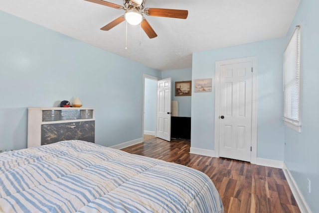 bedroom featuring ceiling fan, wood finished floors, and baseboards