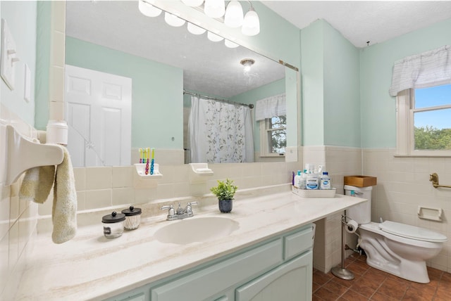 full bath featuring toilet, tile walls, a textured ceiling, and tile patterned floors