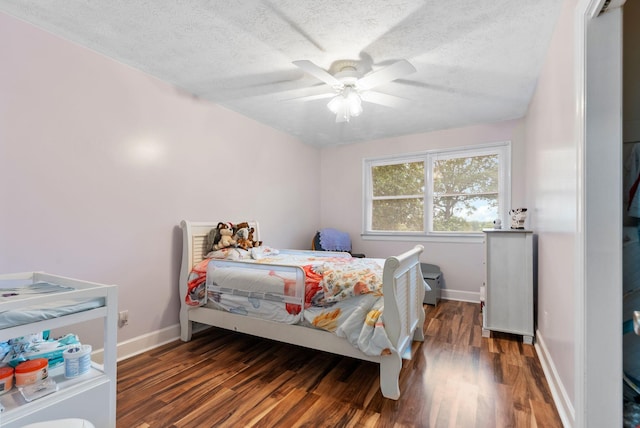 bedroom featuring a textured ceiling, wood finished floors, a ceiling fan, and baseboards