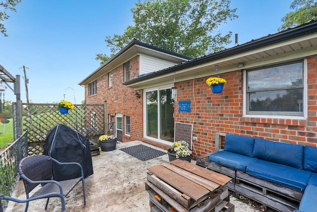 view of patio / terrace with outdoor lounge area, fence, and a grill