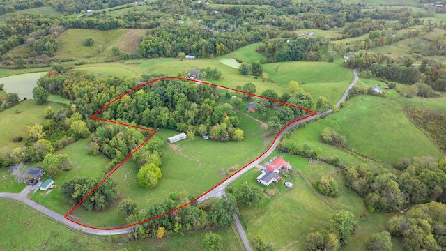 birds eye view of property with a rural view