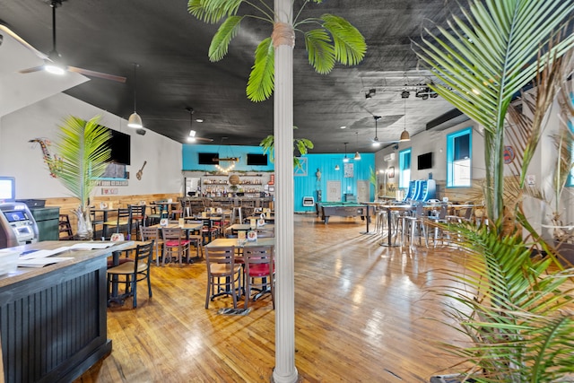 interior space with a ceiling fan and wood-type flooring