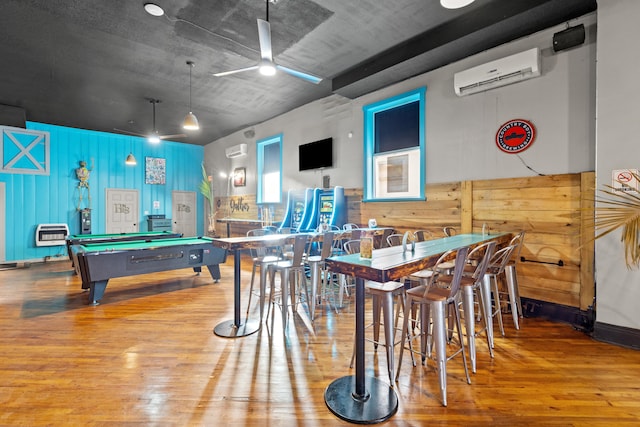 playroom with ceiling fan, pool table, a wall mounted air conditioner, and wood finished floors