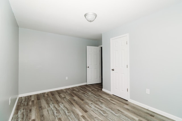 empty room with wood finished floors and baseboards