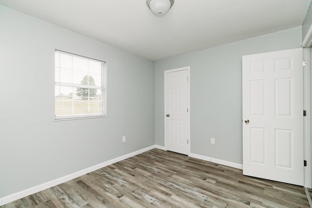 interior space featuring a closet, baseboards, and wood finished floors