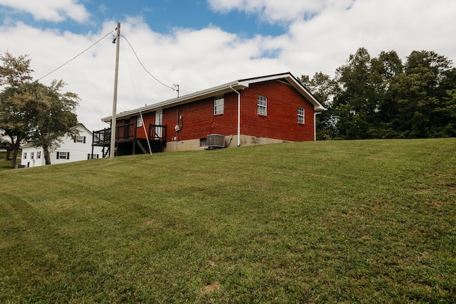 view of home's exterior featuring brick siding and a yard