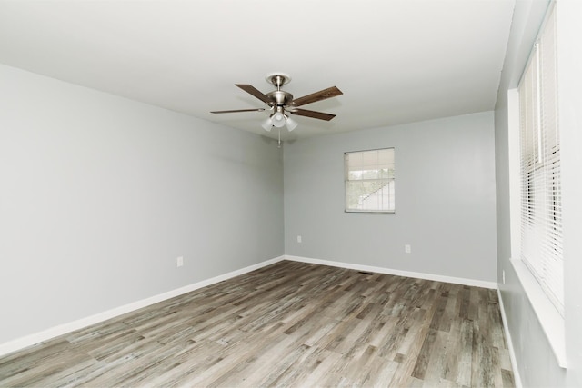 unfurnished bedroom featuring ceiling fan, baseboards, and wood finished floors