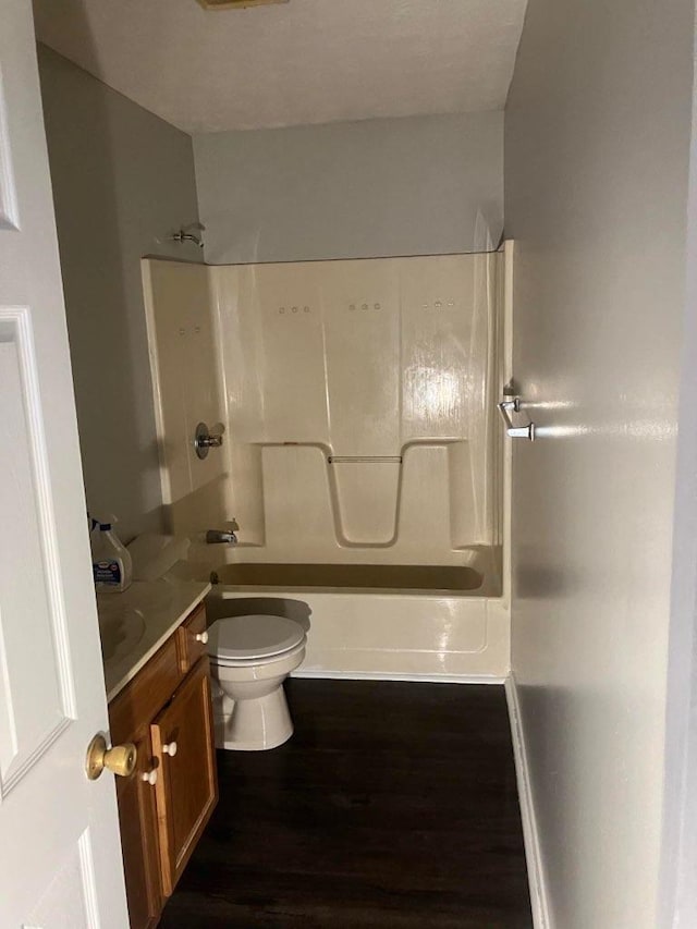 full bathroom with vanity, shower / tub combination, wood finished floors, and toilet