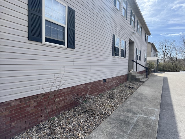 view of home's exterior featuring entry steps and crawl space