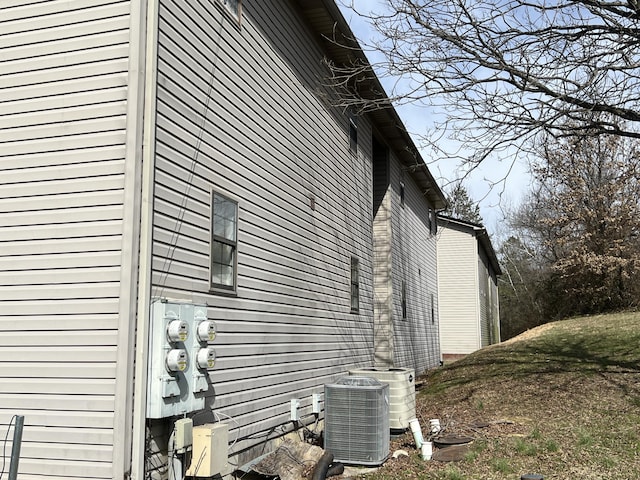 view of side of home featuring cooling unit