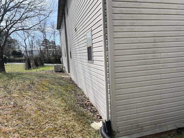 view of side of property featuring central air condition unit