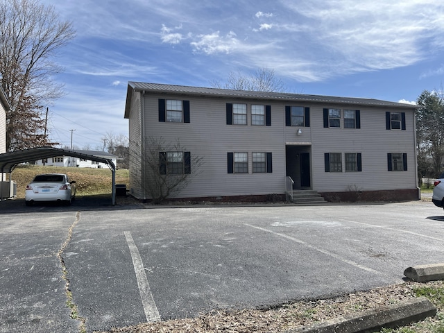 view of front of property featuring metal roof and a carport