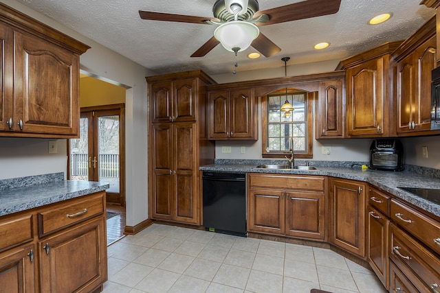 kitchen featuring dishwasher, dark countertops, a sink, and a wealth of natural light