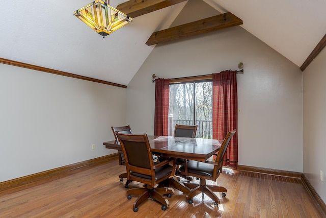 dining area featuring vaulted ceiling with beams, crown molding, baseboards, and wood finished floors