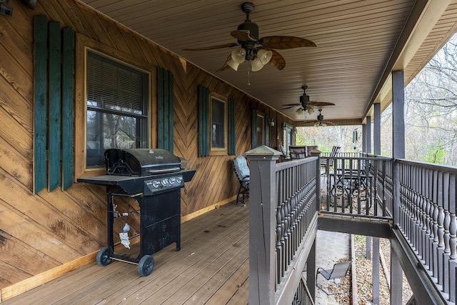 wooden deck with covered porch, ceiling fan, and grilling area