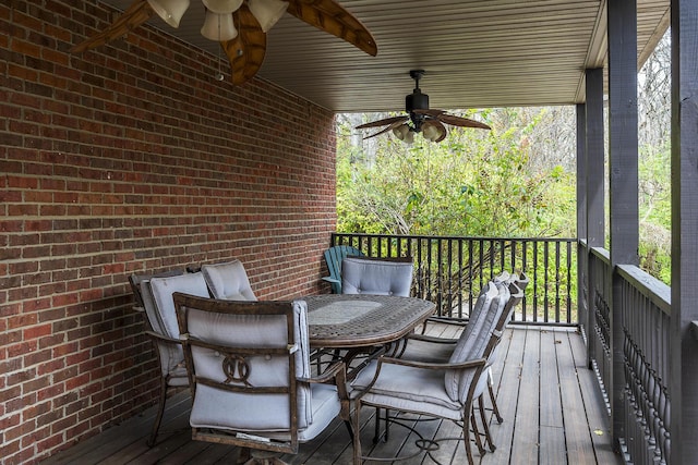 deck with outdoor dining area and a ceiling fan