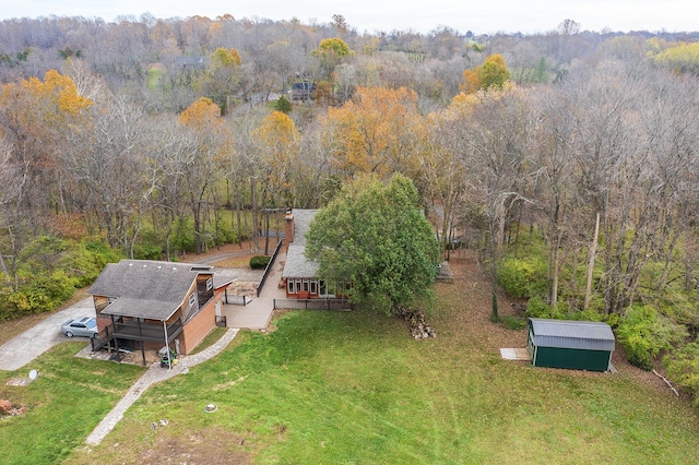 drone / aerial view with a wooded view