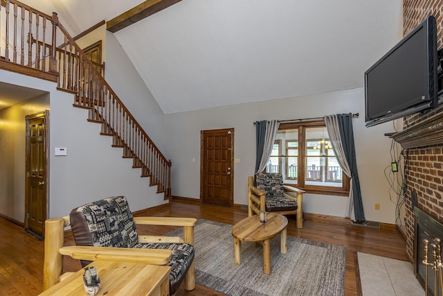 living area with a high ceiling, stairway, light wood-style flooring, and baseboards