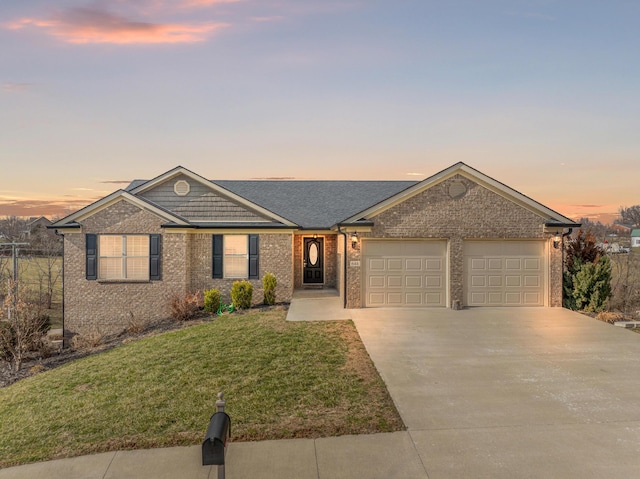 ranch-style house with concrete driveway, brick siding, an attached garage, and a front yard