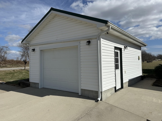 detached garage with concrete driveway