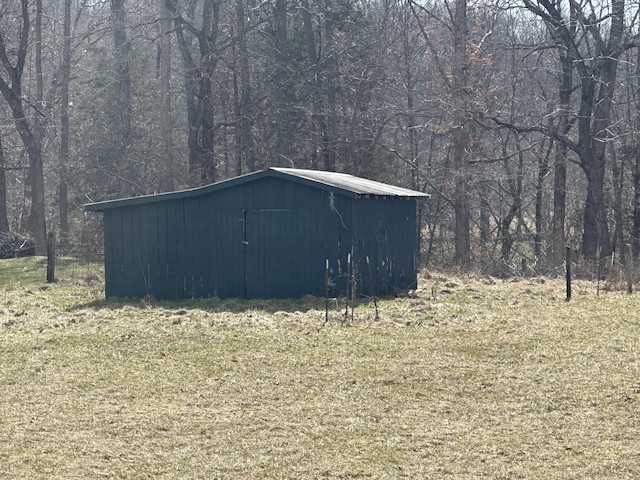 view of pole building featuring a view of trees