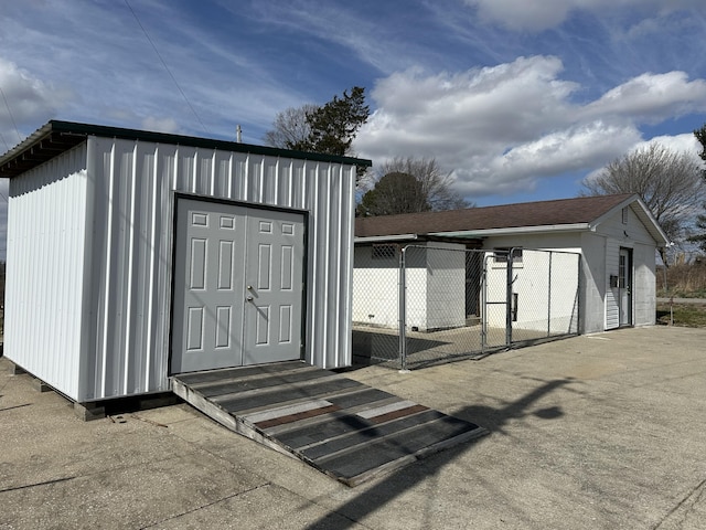 view of shed featuring fence