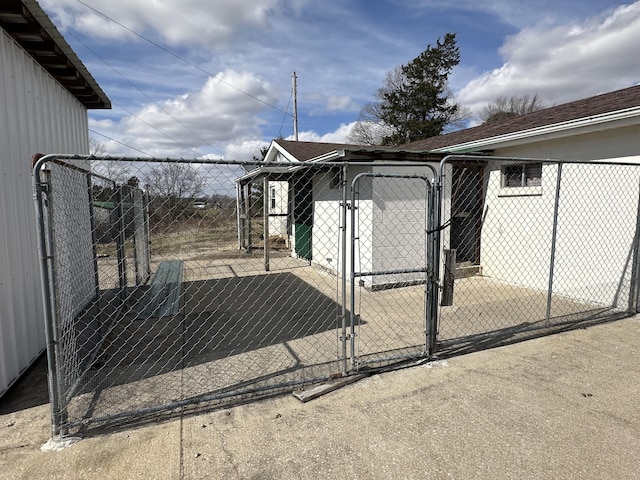 view of gate featuring an outdoor structure and an exterior structure