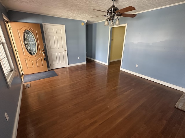 entrance foyer featuring ceiling fan, a textured ceiling, baseboards, and dark wood-type flooring