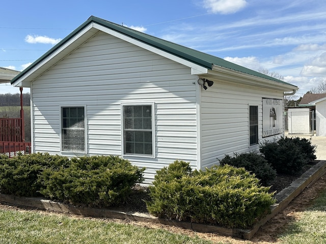 view of side of home featuring metal roof