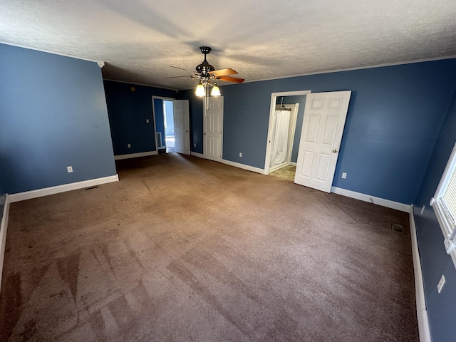 unfurnished room with carpet floors, visible vents, ceiling fan, a textured ceiling, and baseboards