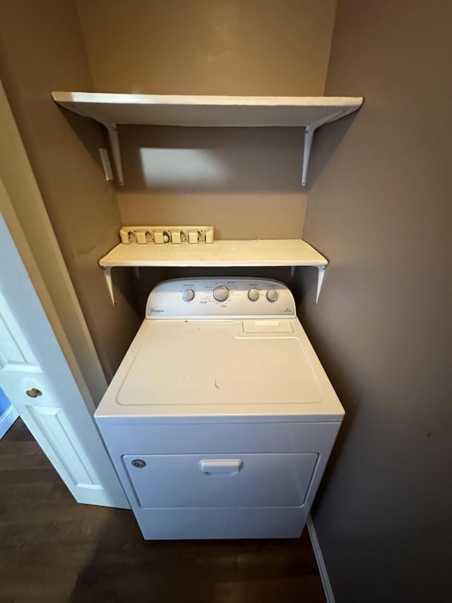 laundry area with washer / dryer, baseboards, laundry area, and dark wood-style flooring