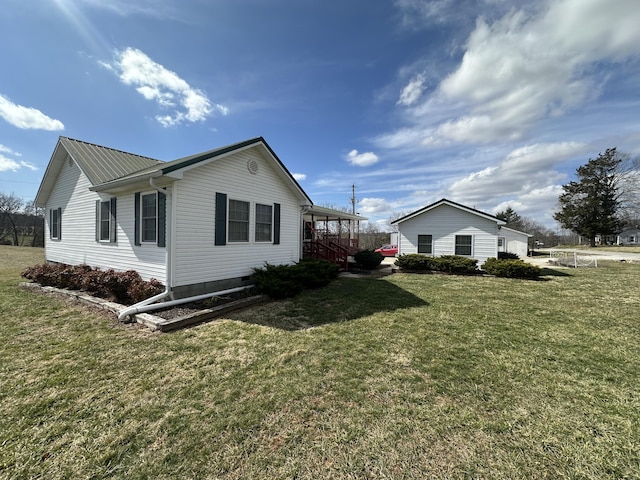 view of property exterior featuring metal roof, crawl space, and a lawn