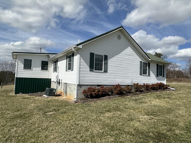 view of side of home with a yard and central air condition unit