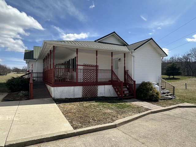 view of front of property featuring covered porch and metal roof