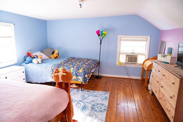 bedroom featuring cooling unit, wood-type flooring, vaulted ceiling, and baseboards