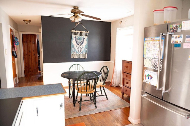 dining space with ceiling fan and light wood finished floors