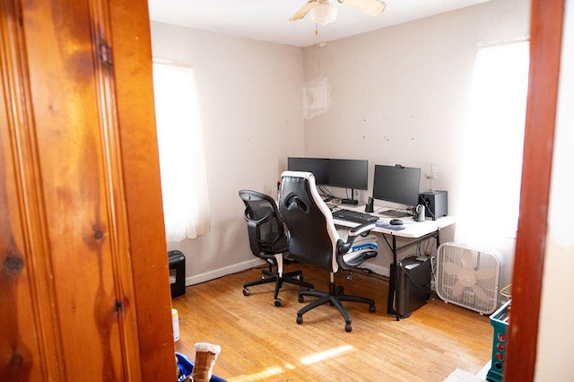 office space with a ceiling fan, baseboards, and wood finished floors