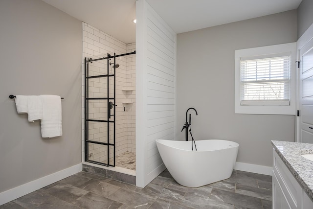 bathroom with a shower stall, baseboards, a freestanding tub, marble finish floor, and vanity