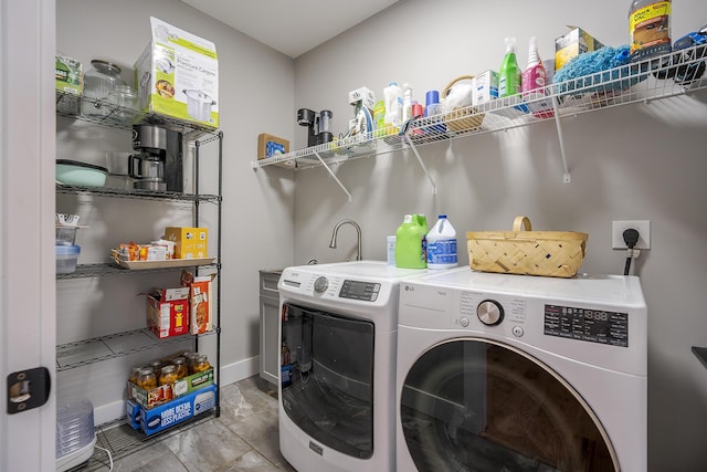 laundry area featuring laundry area, baseboards, and washing machine and clothes dryer