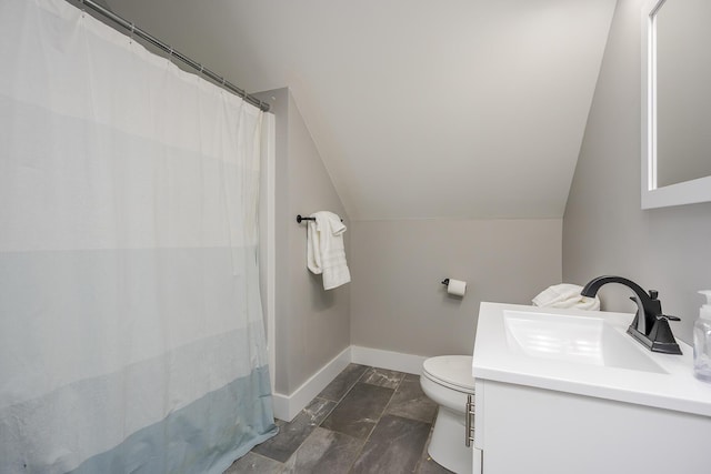 bathroom featuring toilet, marble finish floor, lofted ceiling, baseboards, and vanity