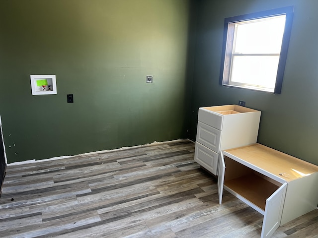 interior space featuring laundry area, hookup for a washing machine, electric dryer hookup, and wood finished floors