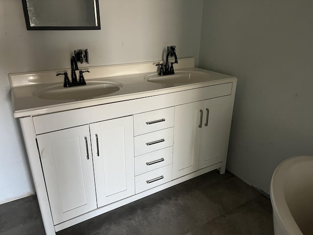 full bathroom with double vanity and a sink