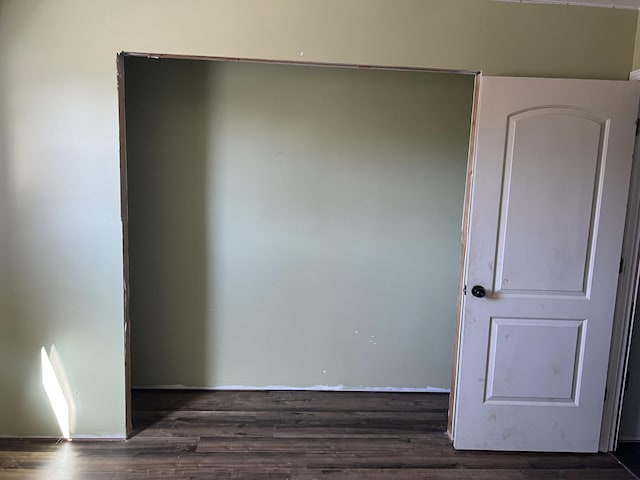 unfurnished room featuring dark wood-style floors