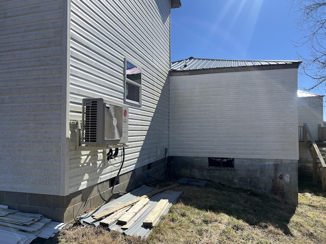 view of property exterior featuring crawl space and metal roof